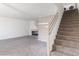 Open living room showcasing fireplace, neutral carpet, and staircase at 2219 Rugged Mesa Dr, Laughlin, NV 89029
