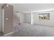 Open living area with carpet, view to the outside, and staircase to upper level at 2219 Rugged Mesa Dr, Laughlin, NV 89029