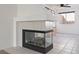 Cozy living room featuring a modern fireplace and neutral tile flooring at 2219 Rugged Mesa Dr, Laughlin, NV 89029