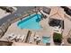Aerial shot of a clean, well maintained community pool, featuring lounge chairs and desert landscaping at 2219 Rugged Mesa Dr, Laughlin, NV 89029