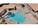 Aerial view of a community pool with spa, lounge chairs, desert landscaping, and shaded patio area at 2219 Rugged Mesa Dr, Laughlin, NV 89029