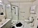 Bathroom featuring updated glass door shower, toilet, and white marble floors at 2232 Aspen Mirror Dr # 203, Laughlin, NV 89029