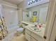 Well-lit bathroom featuring a tub-shower combo and a vanity with ample counter space and a big mirror at 2232 Aspen Mirror Dr # 203, Laughlin, NV 89029