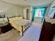 Cozy bedroom with carpet, yellow bedding, and turquoise curtains at 2232 Aspen Mirror Dr # 203, Laughlin, NV 89029