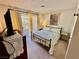 Cozy bedroom featuring a comfortable bed, a floral quilt, and sliding doors to a private balcony at 2232 Aspen Mirror Dr # 203, Laughlin, NV 89029
