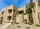 Attractive condo exterior with balconies, mature landscaping, and tan stucco finish at 2232 Aspen Mirror Dr # 203, Laughlin, NV 89029