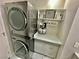 Laundry area featuring stackable LG washer/dryer and marble counters at 2232 Aspen Mirror Dr # 203, Laughlin, NV 89029