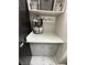 Modern laundry room with marbled countertops, gray cabinets, and stylish storage baskets on open shelving at 2232 Aspen Mirror Dr # 203, Laughlin, NV 89029