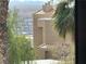 Scenic view of the city and mountains framed by lush trees and the architectural details of the building at 2232 Aspen Mirror Dr # 203, Laughlin, NV 89029