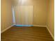 Bright bedroom with wood-look floors and large window with vertical blinds at 2900 Sunridge Heights Pkwy # 816, Henderson, NV 89052
