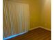 Bright bedroom with wood-look floors and large window with vertical blinds at 2900 Sunridge Heights Pkwy # 816, Henderson, NV 89052