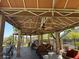 Outdoor cabana area with ceiling fans, ample seating, stone supports and a grill at 2900 Sunridge Heights Pkwy # 816, Henderson, NV 89052