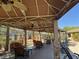 Outdoor cabana area with ceiling fans, ample seating, stone supports and a grill at 2900 Sunridge Heights Pkwy # 816, Henderson, NV 89052