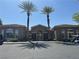 Community clubhouse with arched entrance, tall palm trees and visitor parking at 2900 Sunridge Heights Pkwy # 816, Henderson, NV 89052