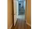 Hallway leading to the kitchen with wood-look floors and neutral colored walls at 2900 Sunridge Heights Pkwy # 816, Henderson, NV 89052