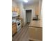 Well-lit kitchen features white appliances, wooden cabinets, and granite countertops at 2900 Sunridge Heights Pkwy # 816, Henderson, NV 89052