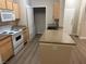 Kitchen area with white appliances, island and adjacent laundry area at 2900 Sunridge Heights Pkwy # 816, Henderson, NV 89052