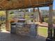 Inviting outdoor grill area featuring stone accents, stainless steel appliances, and shaded seating for enjoyable cooking at 2900 Sunridge Heights Pkwy # 816, Henderson, NV 89052