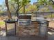 Outdoor kitchen features stainless steel BBQ, stone facade and refrigerator at 2900 Sunridge Heights Pkwy # 816, Henderson, NV 89052