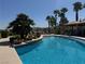 Scenic swimming pool surrounded by lush greenery, palm trees, and shaded seating with lounge chairs at 2900 Sunridge Heights Pkwy # 816, Henderson, NV 89052