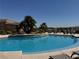 Community pool has a shallow end with chairs, sunning deck, and landscaping at 2900 Sunridge Heights Pkwy # 816, Henderson, NV 89052