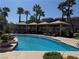 Stunning pool view surrounded by palm trees, lounge chairs, and shaded seating areas for relaxation and entertainment at 2900 Sunridge Heights Pkwy # 816, Henderson, NV 89052