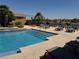 Community pool with lounge chairs, surrounded by lush landscaping on a sunny day at 2900 Sunridge Heights Pkwy # 816, Henderson, NV 89052