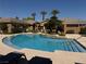 Community pool is surrounded by lush landscaping, seating and a sunning deck at 2900 Sunridge Heights Pkwy # 816, Henderson, NV 89052