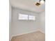 This bedroom features neutral carpet, white walls, and a window at 304 Elliott Ave, Las Vegas, NV 89106
