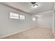 This bedroom features neutral carpet, white walls, and a window at 304 Elliott Ave, Las Vegas, NV 89106