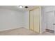 Neutral bedroom featuring a light fixture, neutral carpet and a double sliding door closet at 304 Elliott Ave, Las Vegas, NV 89106