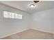 This bedroom features neutral carpet, white walls, and a window at 304 Elliott Ave, Las Vegas, NV 89106