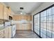 The kitchen features lots of counter space, an oven, a ceiling fan, and a sliding glass door at 304 Elliott Ave, Las Vegas, NV 89106