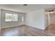 Bright and airy living room featuring new wood-look flooring, fresh paint, and an abundance of natural light at 304 Elliott Ave, Las Vegas, NV 89106