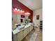 Bathroom featuring double sinks with a large countertop, and a red accent wall at 3400 Cabana Dr # 1061, Las Vegas, NV 89122
