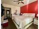 Primary bedroom featuring a large bed, and red accent wall at 3400 Cabana Dr # 1061, Las Vegas, NV 89122