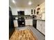 Bright kitchen featuring white cabinets, stainless steel appliances, and hardwood floors at 3400 Cabana Dr # 1061, Las Vegas, NV 89122
