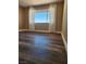 Neutral bedroom featuring hardwood floors, window and light-colored curtains at 4128 Annie Oakley Dr, Las Vegas, NV 89121