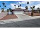 Single-story home featuring a two-car garage, low-maintenance desert landscaping, and a well-maintained exterior at 4128 Annie Oakley Dr, Las Vegas, NV 89121