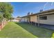 Large grassy backyard with a covered patio area perfect for outdoor gatherings and relaxation at 4347 S Mojave Rd, Las Vegas, NV 89121