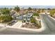An aerial view featuring a two-story home with solar panels, landscaping and the surrounding neighborhood at 4394 El Campana Way, Las Vegas, NV 89121