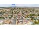 Expansive aerial view of a residential area with homes, streets, and Boulder Station in the distance at 4394 El Campana Way, Las Vegas, NV 89121