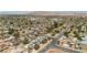 Wide aerial view of a neighborhood featuring homes with solar panels and mountain views in the background at 4394 El Campana Way, Las Vegas, NV 89121
