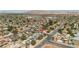 Wide aerial view of a neighborhood featuring homes with solar panels and mountain views in the background at 4394 El Campana Way, Las Vegas, NV 89121