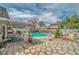 Expansive backyard with a refreshing pool, patio area, and lush landscaping at 4394 El Campana Way, Las Vegas, NV 89121