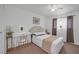 Cozy bedroom offers a white desk and chair alongside a comfortable bed at 4394 El Campana Way, Las Vegas, NV 89121