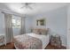 Comfortable bedroom featuring a ceiling fan, bright window, and hardwood floors at 4394 El Campana Way, Las Vegas, NV 89121