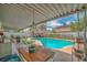 Relaxing backyard featuring a sparkling pool and shaded patio, perfect for outdoor gatherings at 4394 El Campana Way, Las Vegas, NV 89121