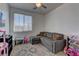 Cozy bedroom featuring a pull-out couch, soft rug, and ample lighting at 5629 Portage Lake Ct, Las Vegas, NV 89130