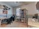 Bright bedroom with desk, bookshelf, and neutral color scheme at 5629 Portage Lake Ct, Las Vegas, NV 89130